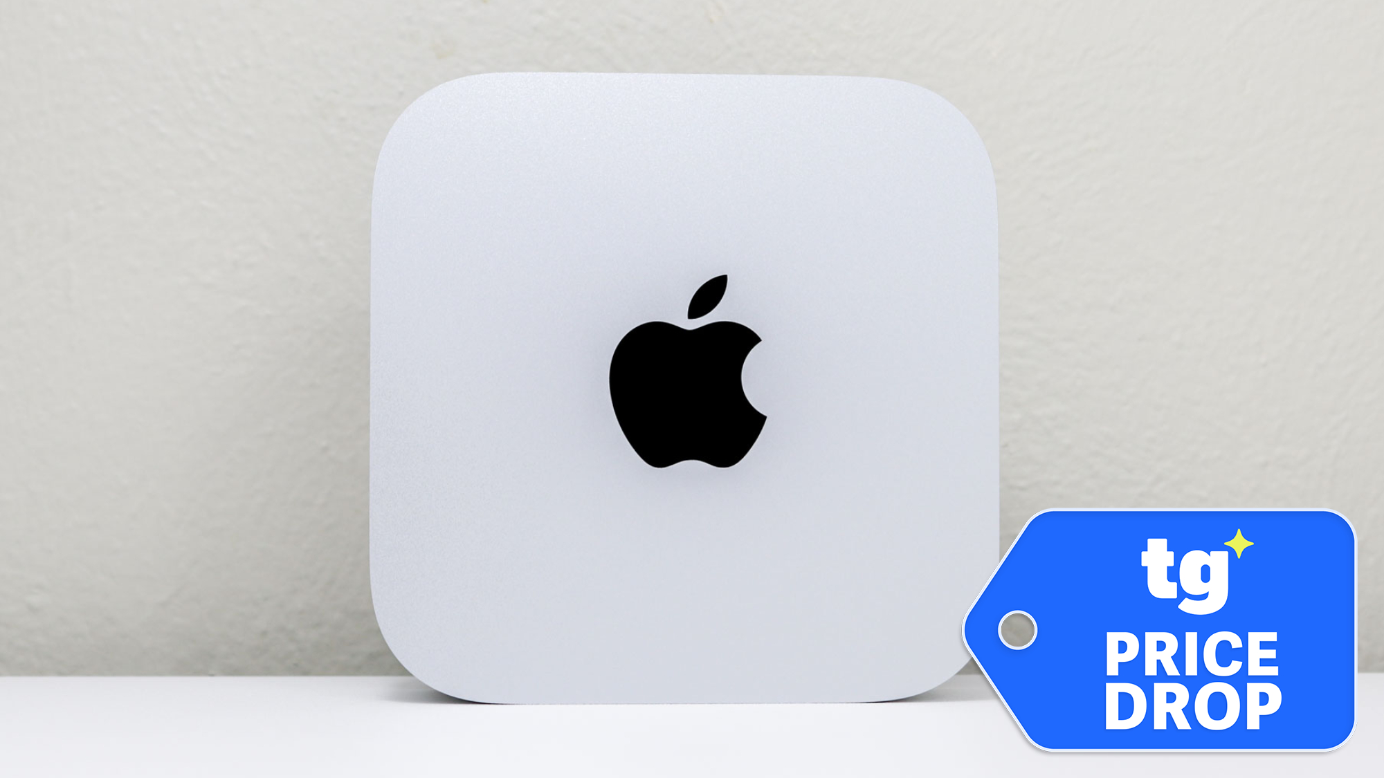 Mac mini M4 shown upright with Apple logo on desk