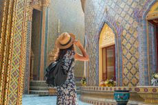 Woman traveler at Wat Ratchabophit Temple in Bangkok in a summer day