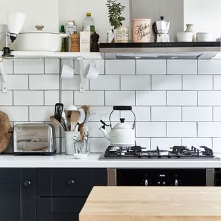kitchen with white tiled backsplash and gas hob