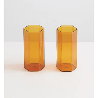 two tall glasses in tinted orange and a hexagonal shape