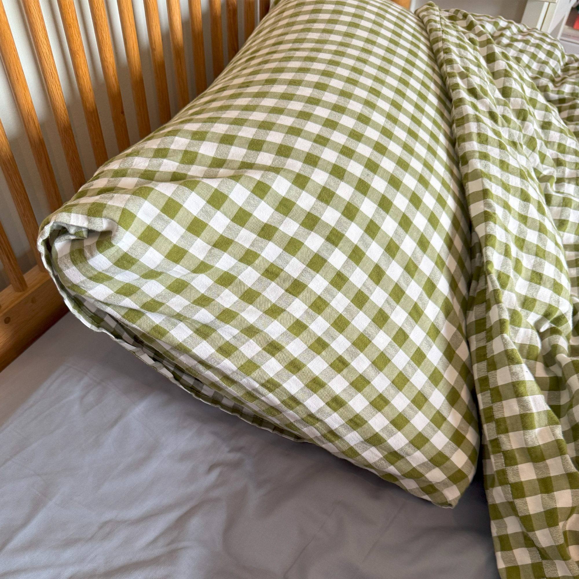 Simba Hybrid Firm pillow in a green gingham pillowcase