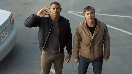 John Stewart with his hand raised as he and Hal Jordan look at the sky in Lanterns on HBO Max