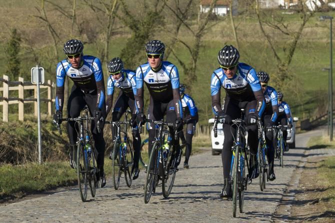 Team NetApp-Endura riders on the Haaghoek sector of cobbles.