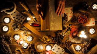 Fall Equinox 2022: n the hands of fortune tellers old book with spells. The attributes of the occult - stock photo