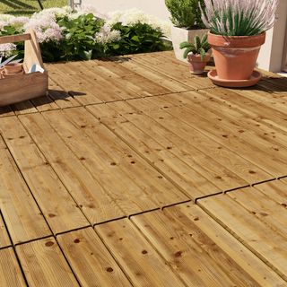 Light wood decking boards with pot plants
