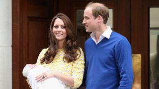 Kate Middleton holds baby Princess Charlotte and stands next to Prince William outside the hospital in May 2, 2015