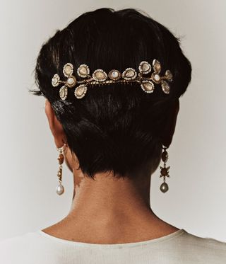 Model wears hair jewellery and earrings by Goossens