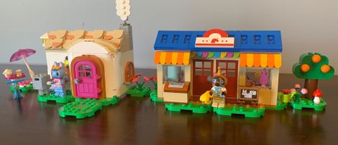 Lego Nook's Cranny & Rosie's House sets on a wooden surface