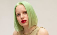 light green straight bobbed hair by Bleach London with red lips and bleached brows 