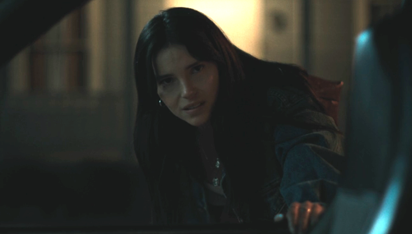 Inde Navarrette looking into Bear's car in Obsession