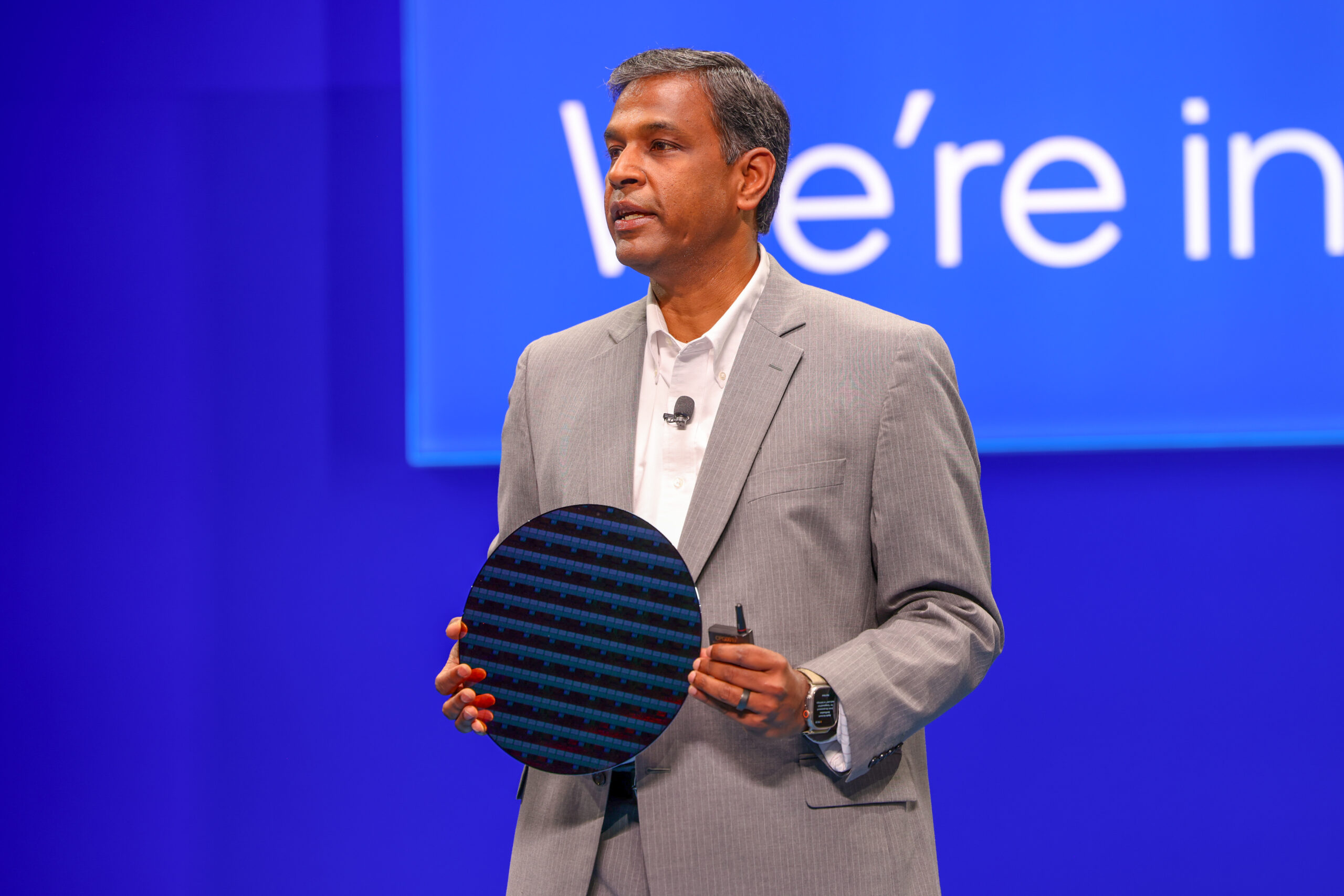 Naga Chandrasekaran, Intel Foundry Chief Technology and Operations Officer, displays a wafer made on the Intel 14A process node during a keynote at Intel Foundry Direct Connect on Tuesday, April 29, 2025 in San Jose, California.