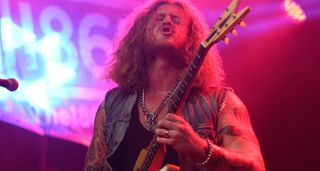 Jared James Nichols plays his Gibson Futura on a stage lit up in red-pink.