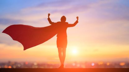 A woman wears a superhero cape that flaps in the wind.