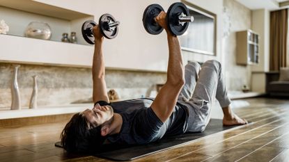 Man doing dumbbell workout at home