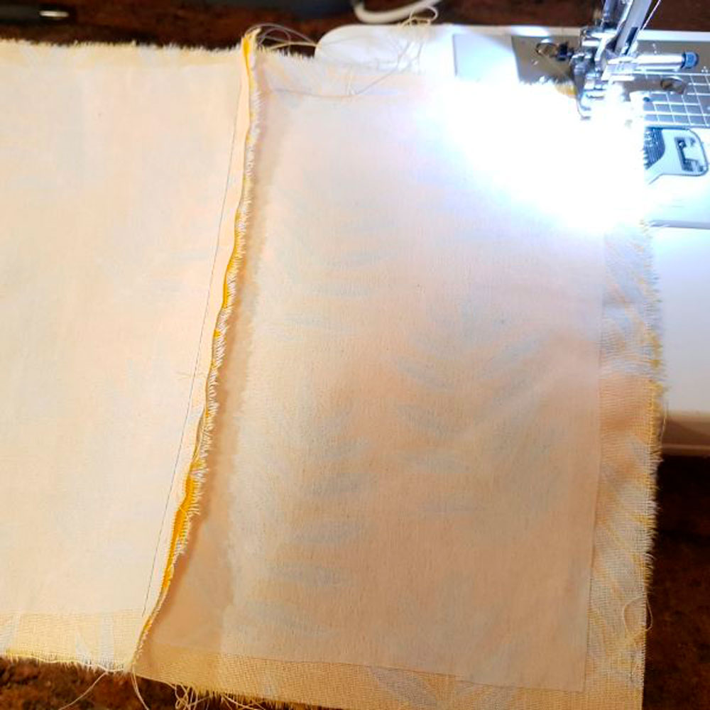 sewing machine stitching fabric piece