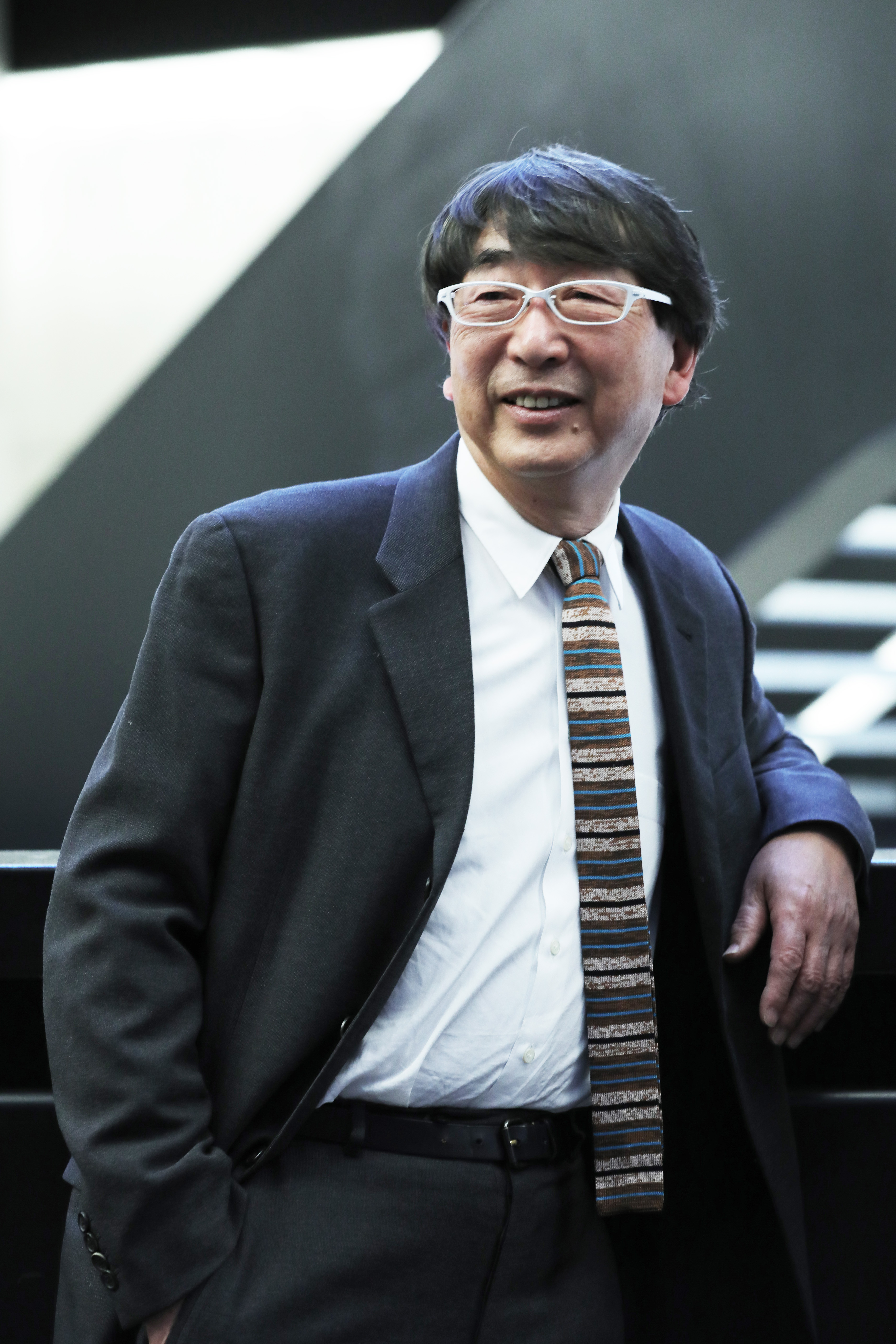 portrait of architect Toyo Ito, smiling, in a suite