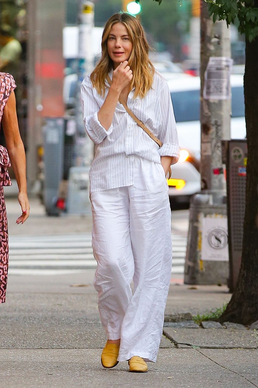 Michelle Monaghan wearing a white button-down shirt and white linen pants with yellow shoes in NYC
