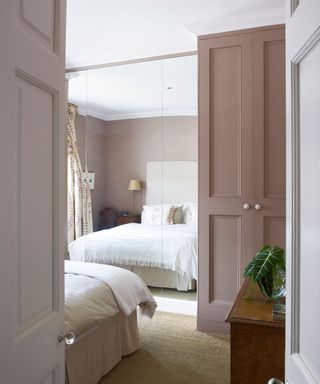 bedroom with large mirror and pink wardrobe