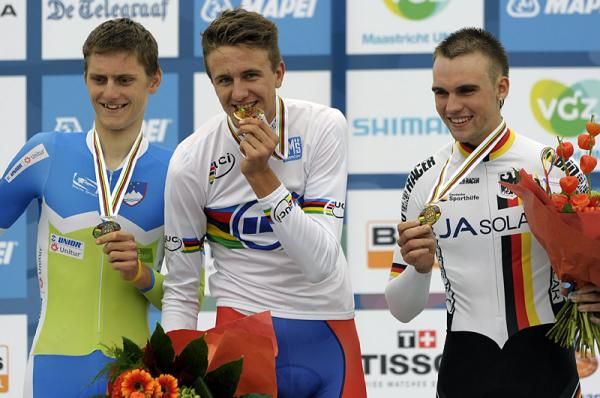 The junior men's time trial world championship podium pose for photographers.