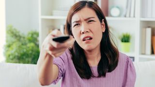 Woman looking confused at a TV