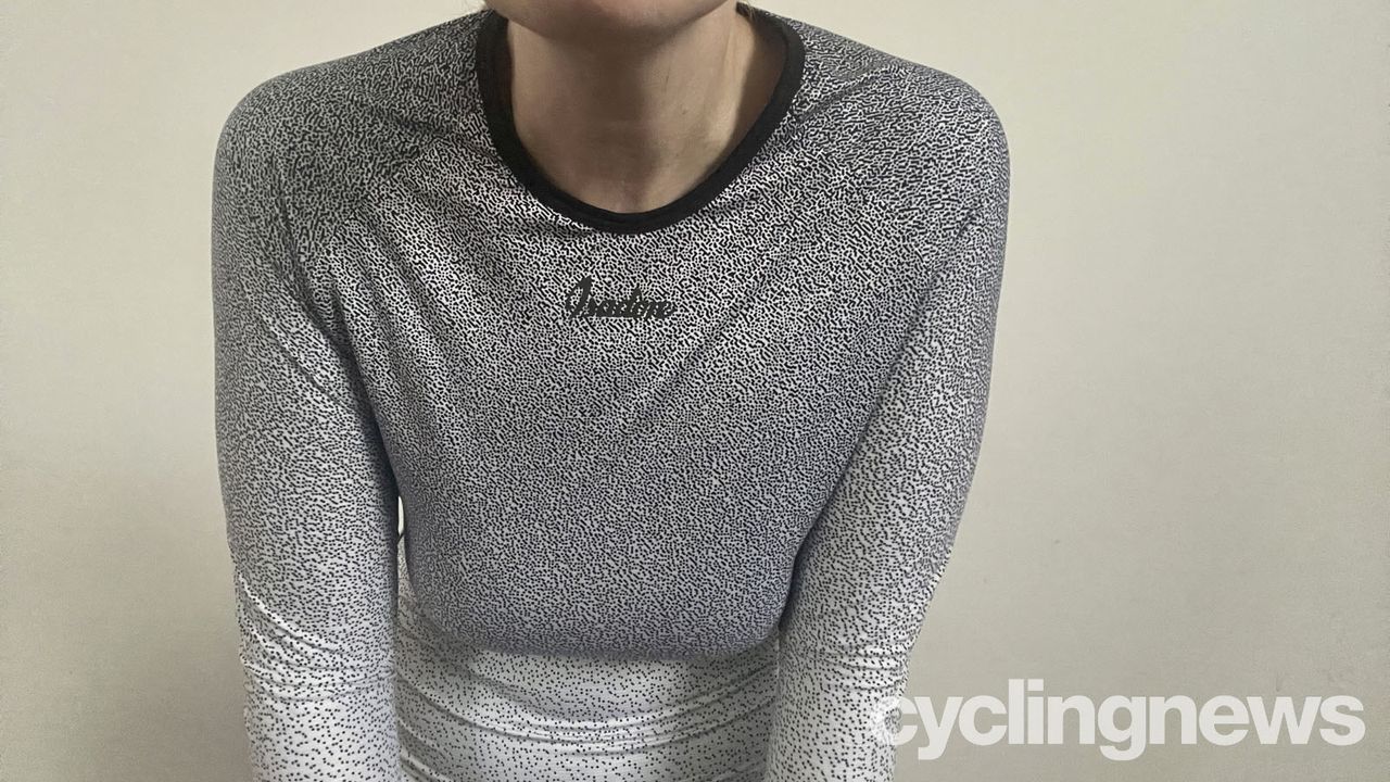 A close up view of the reviewer's chest and neck, she's hunched forward, displaying the way the large neck area gapes
