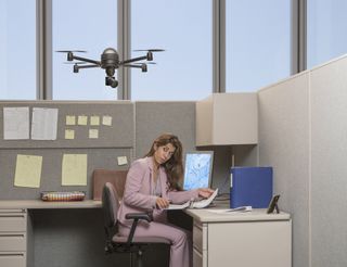 A worker being monitored by a drone in the workplace
