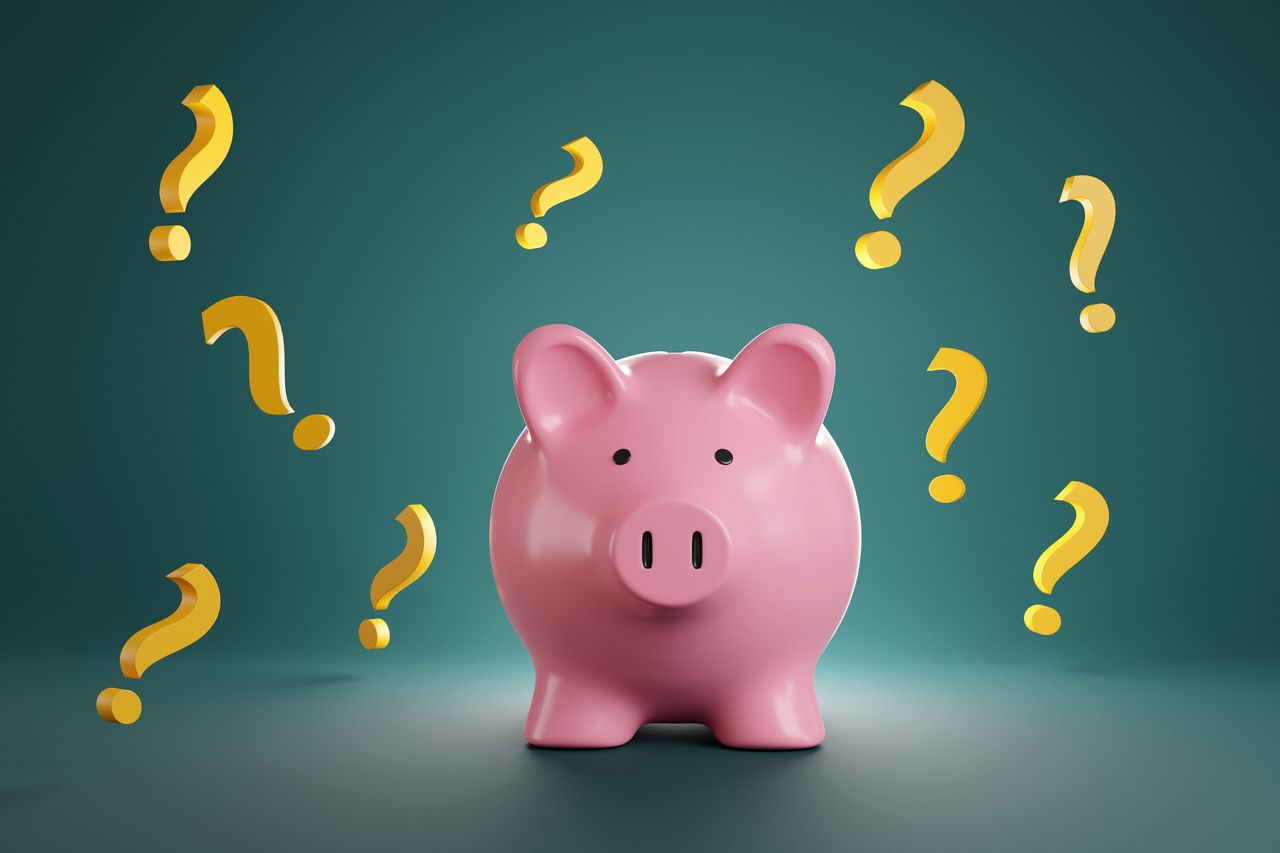 Pink piggy bank surrounded by many yellow question marks on green background. 