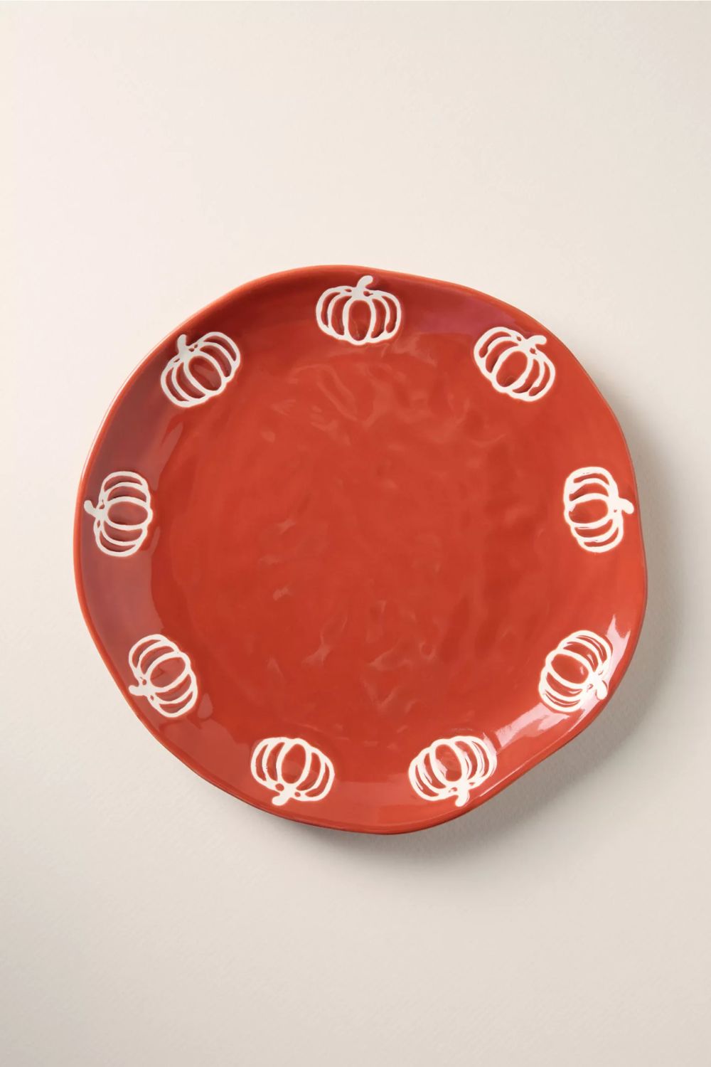 Orange dessert plate with white pumpkin motif