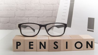 Glasses on top of blocks spelling out pension