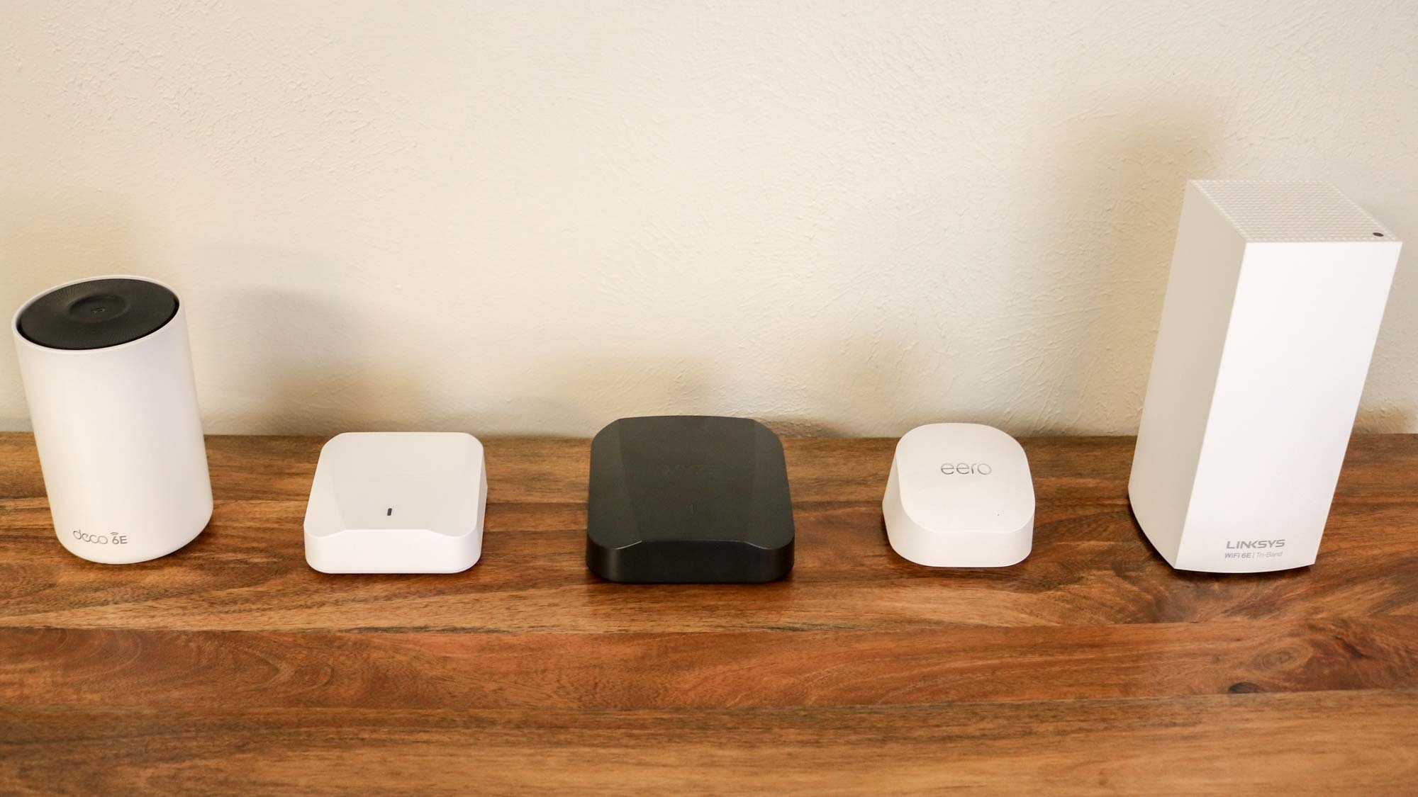 Several of the best mesh Wi-Fi systems laid out on a shelf
