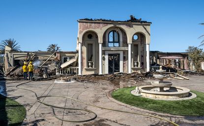 Firefighters puts out hot spots at a house on Vista Court in Laguna Niguel, CA on Thursday, May 12, 2022. 