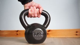  Amazon Basics Cast Iron Kettlebell being held in a hand