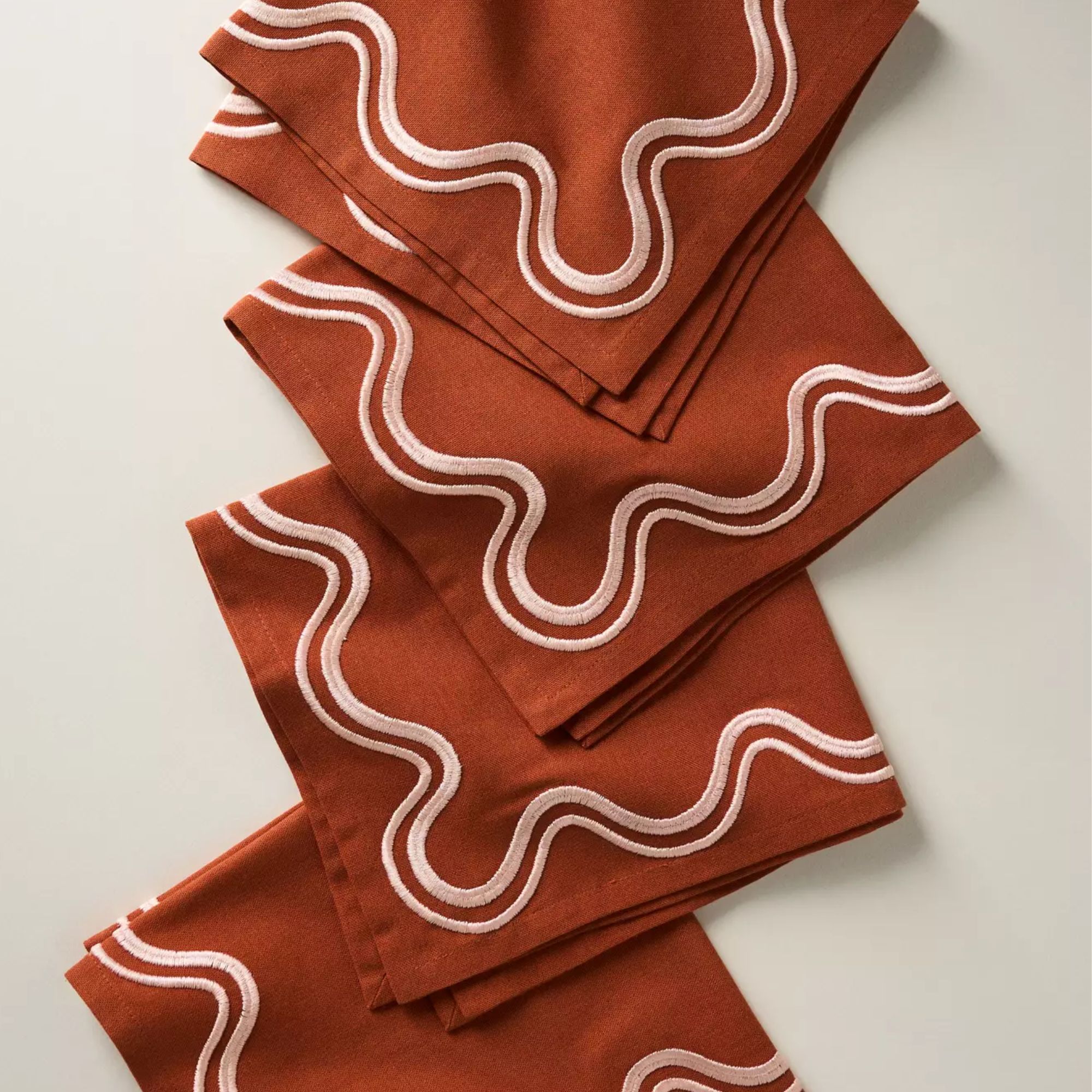 Pumpkin-colored napkins with a white squiggle trim