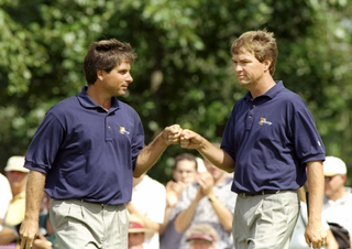 Fred Couples and Davis Love III fist bump at the Presidents Cup