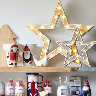 Kitchen shelves with Chrsitmas decorations and star lights