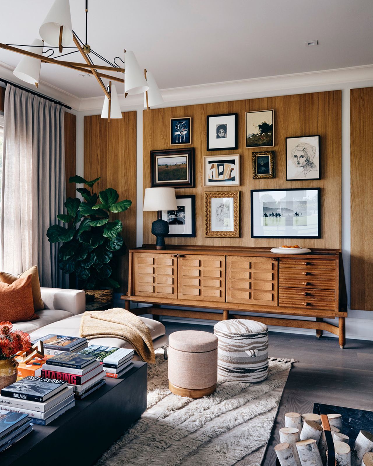 a living room with a coffee table stacked with books