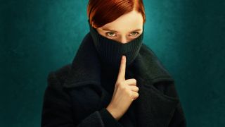 A masked woman raises a finger to her lips in promo art for FX's Say Nothing.