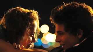 Maika Monroe and Timothee Chalament look into each other's eyes in Hot Summer Nights