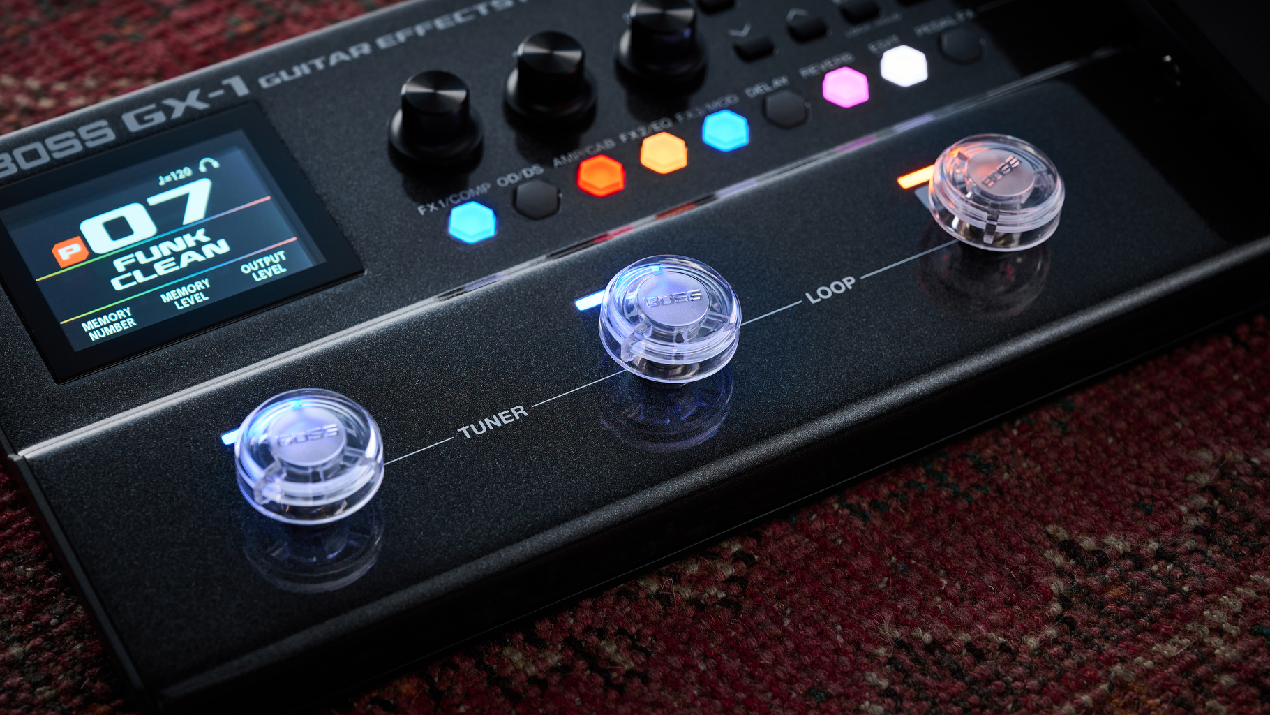 The footswitches of the Boss GX-1 multi-effects pedal with Boss toppers on them