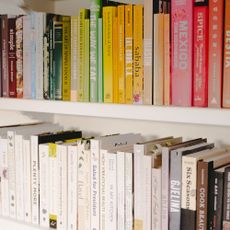 bookshelves organised in rainbow order