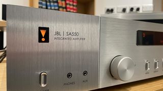 JBL SA550 integrated amplifier close up on front inputs and control dial showing JBL logo