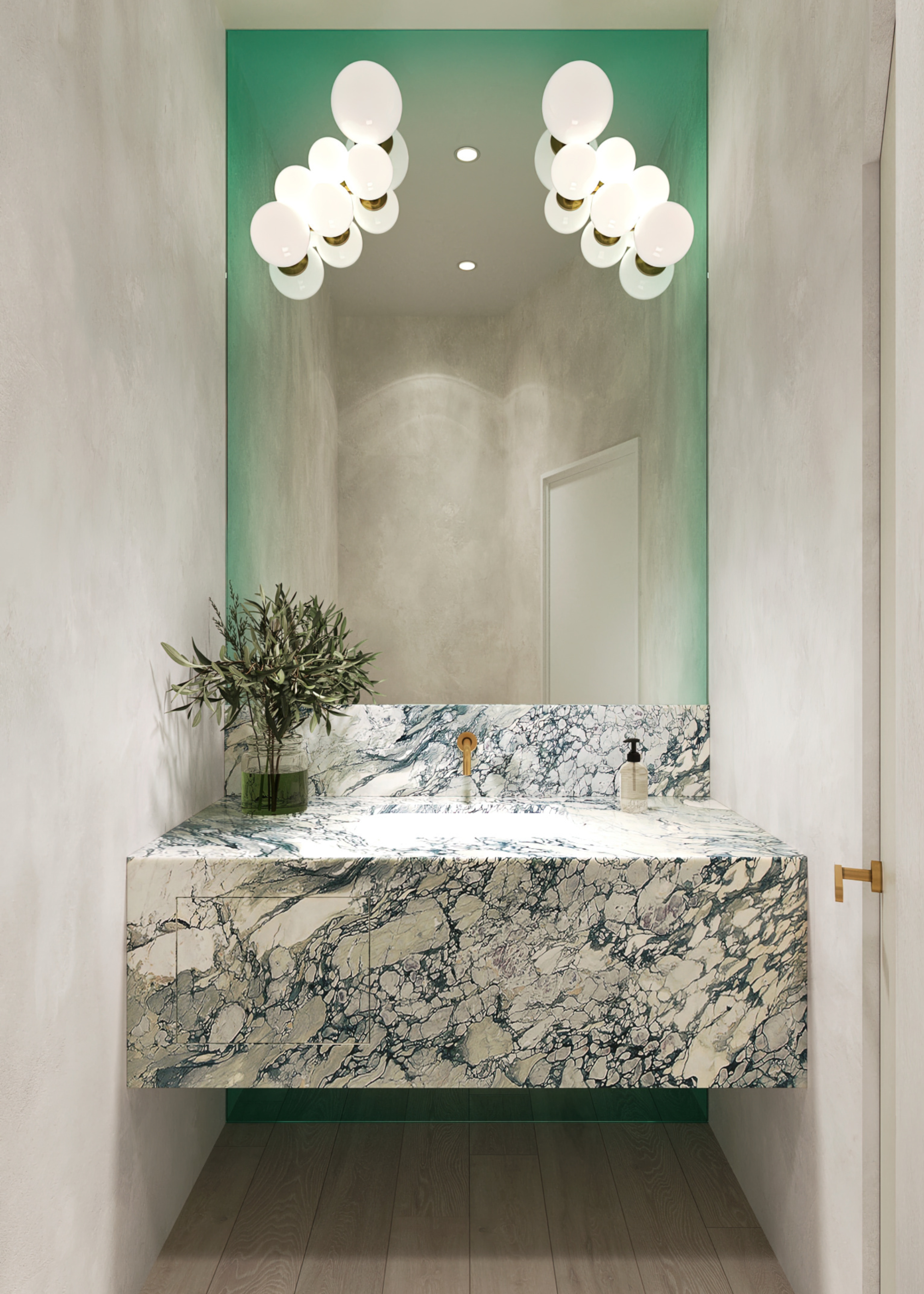 a powder room with marble sink with a small plant next to it, cluster lights on both sides of the mirror which has an ombre green border surrounded by greige walls
