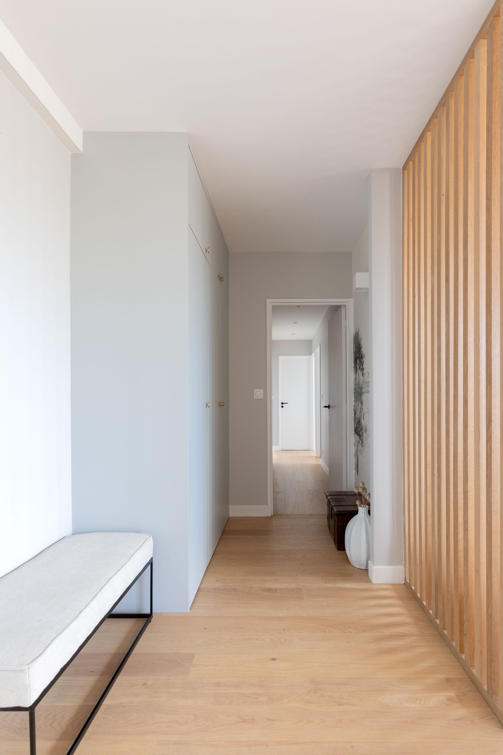 white entryway with wooden panelling