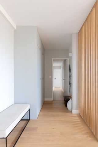 white entryway with wooden panelling