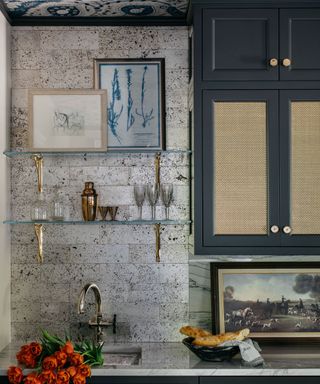 Dark blue kitchen with marble splashback