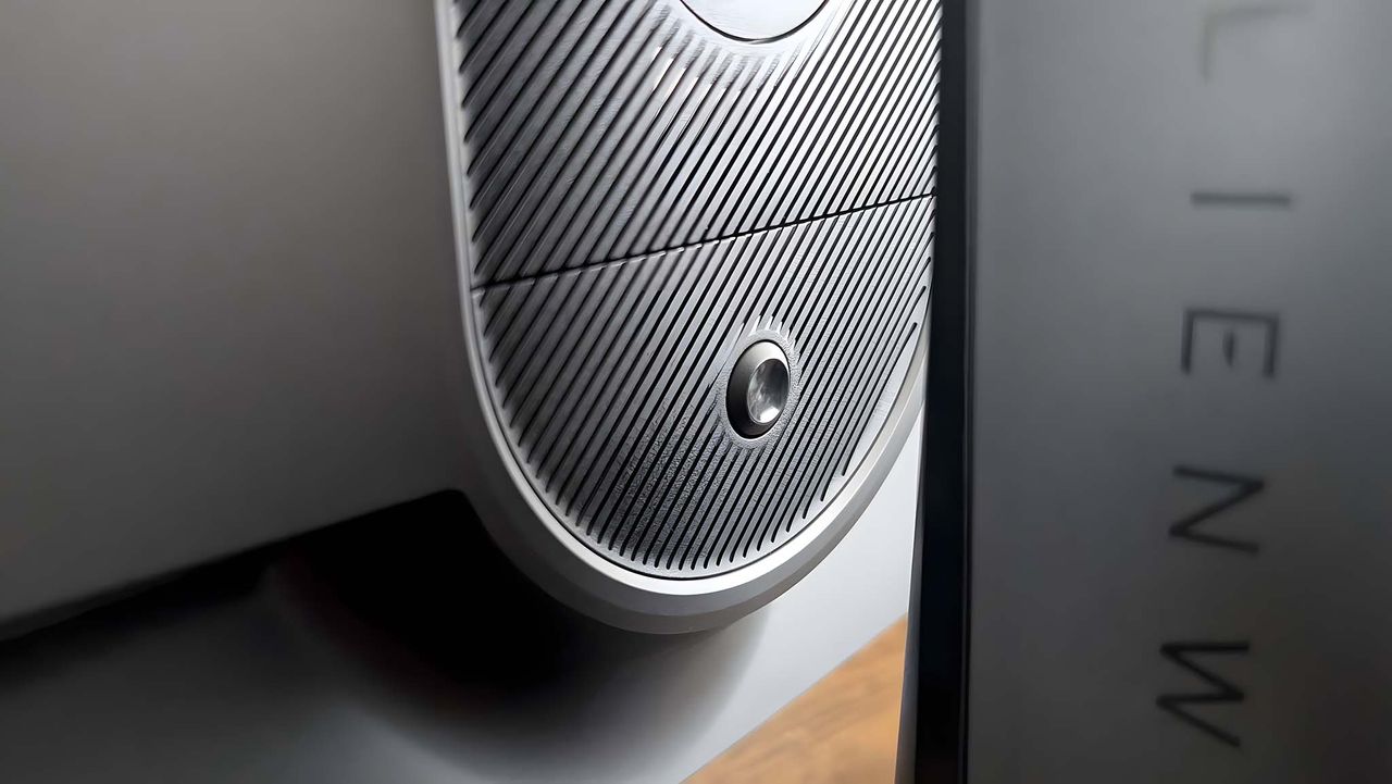 Close up of the stand release button on the back of the Alienware AW2725QF Gaming Monitor.