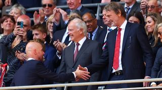 Manchester United manager Erik ten Hag shakes the hand of the club's minority owner Sir Jim Ratcliffe after victory in the FA Cup final against Manchester City at Wembley in May 2024.