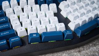 A black Keychron Q14 Max Alice keyboard with white, blue and teal keycaps