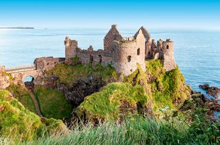 The ruins of Dunluce Castle, County Antrim, at sunrise