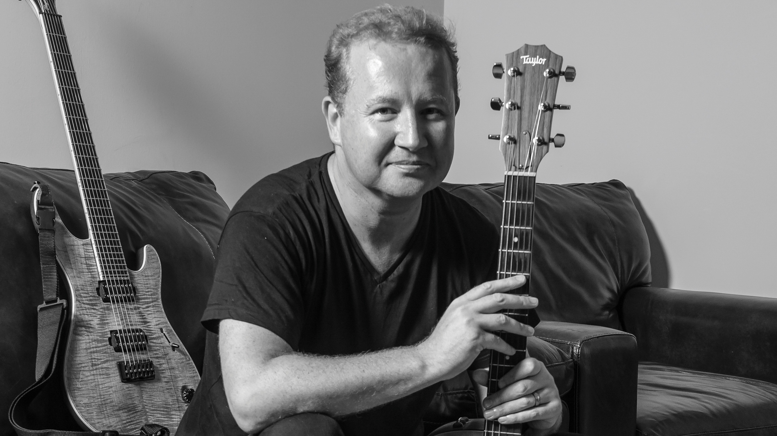 Dec Burke poses with two guitars